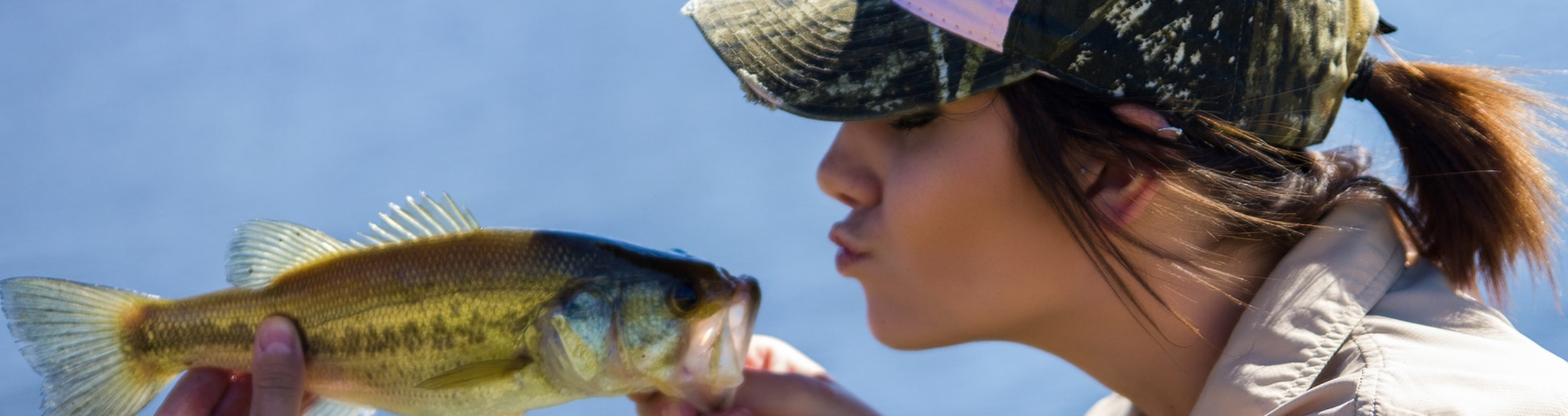 girl kissing fish